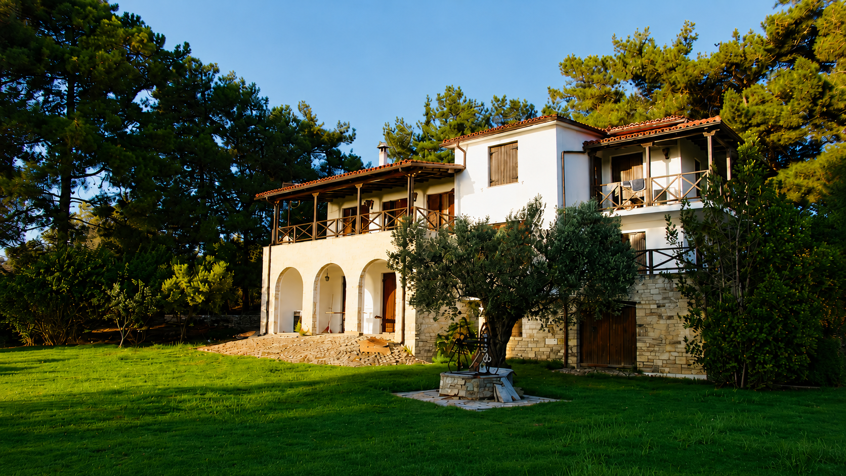 Villa King Filippos surrounded by lawn and pine trees