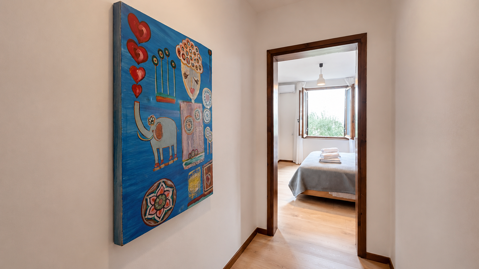 Art-filled passage leading to a bedroom