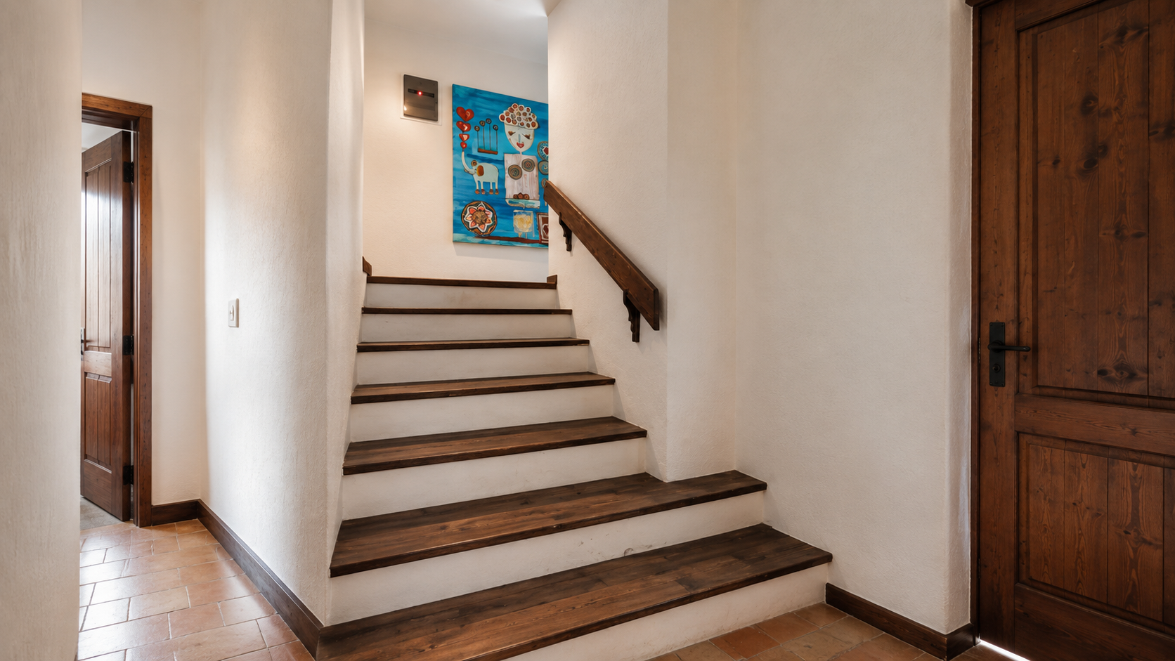 Wood-trimmed staircase through the villa