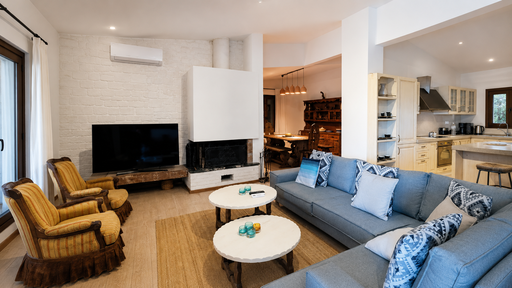 Open-plan lounge, fireplace and kitchen