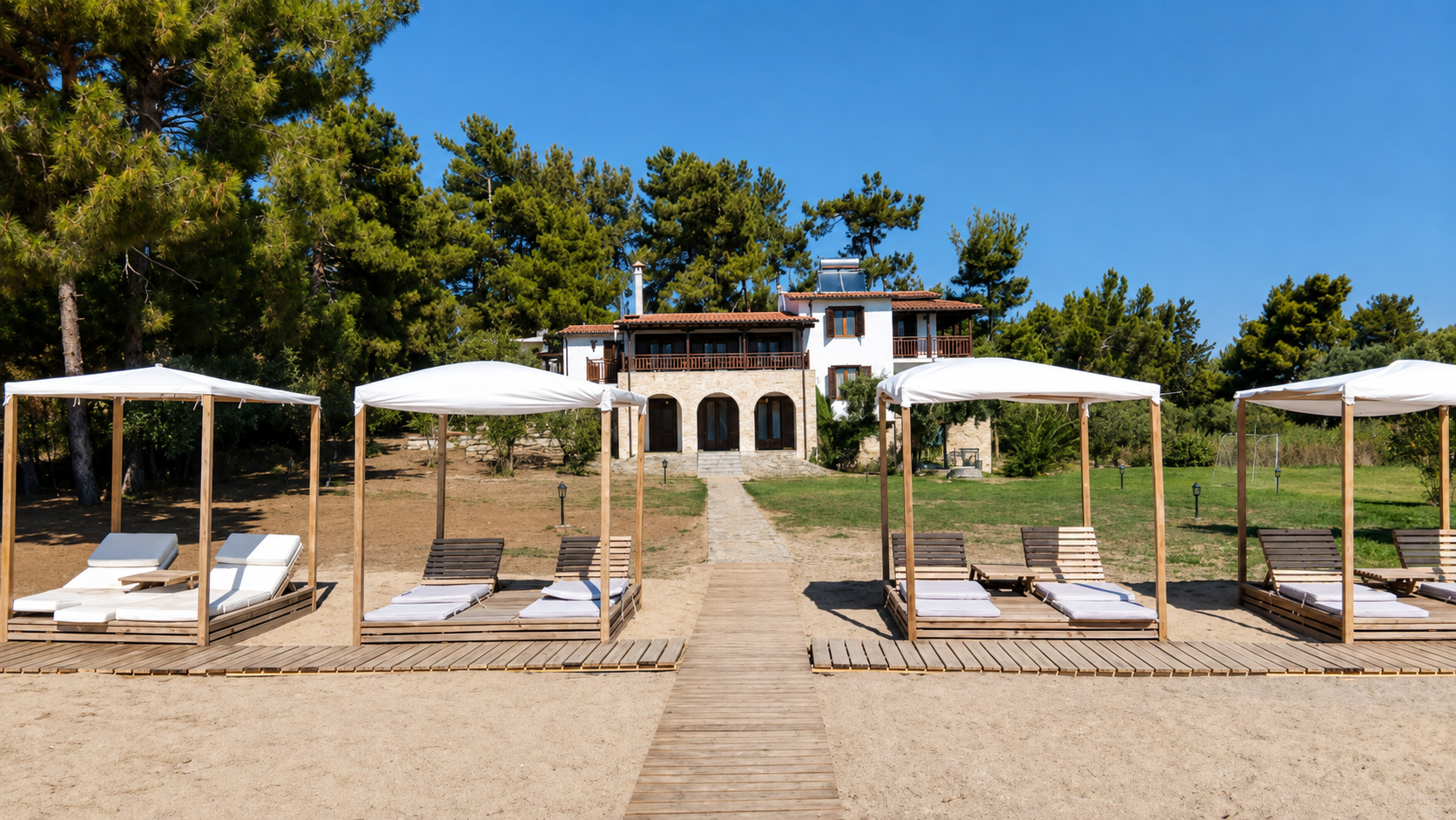 Beach cabanas with the villa directly behind